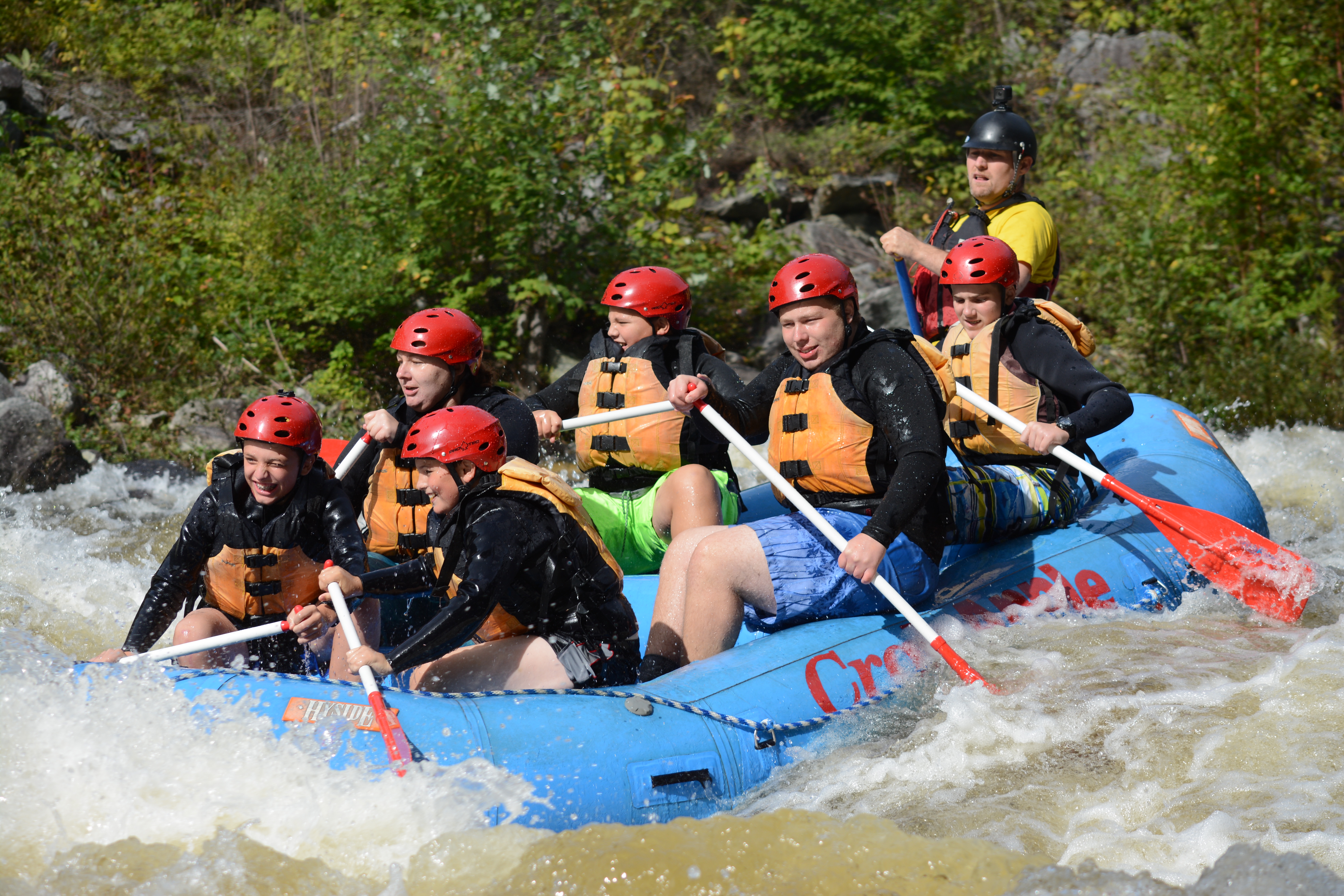Boy Scout troop rafting down a river.