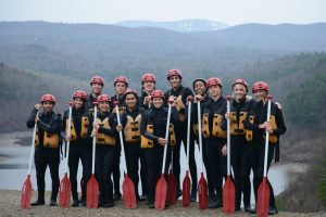 College students getting ready to go on a whitewater rafting trip.