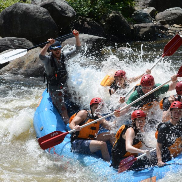 Group of rafters about to fall out of their raft.