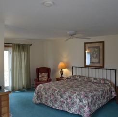 King Jacuzzi Room including king sized bed with a flowered comforter