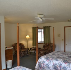 Sitting area with windows visible from two queen beds