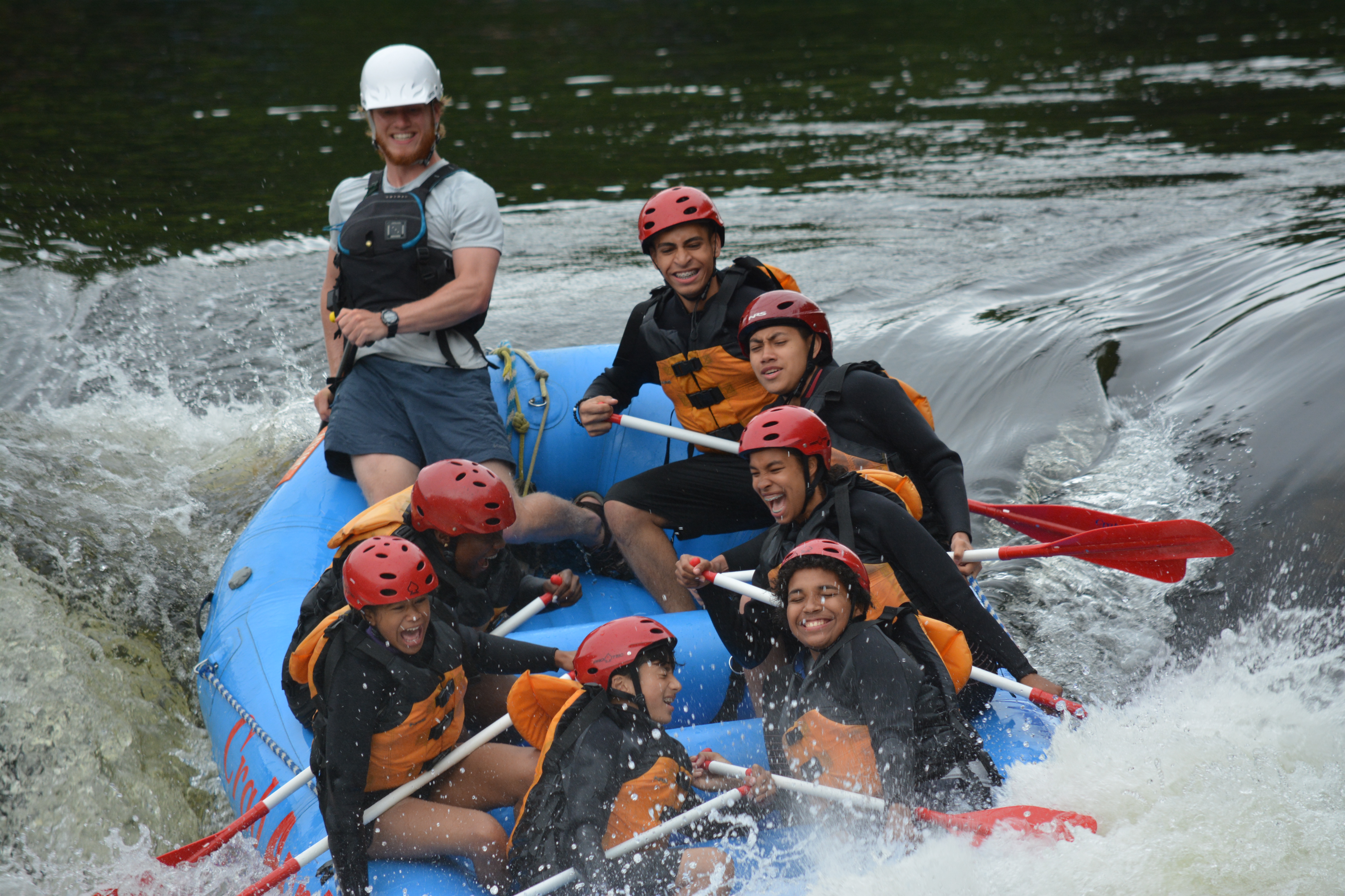 Youth group rafting down a river.