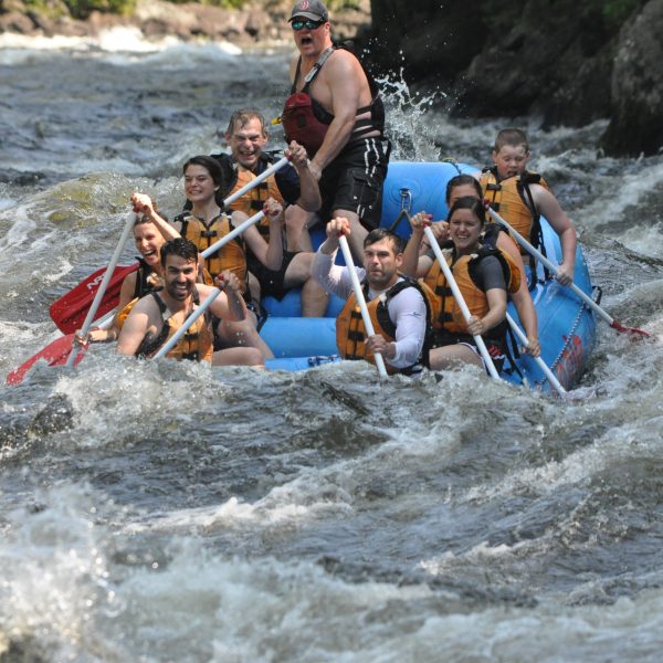 Group of eight rafts down the Kennebec River.