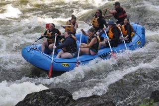 group of rafters going down the river