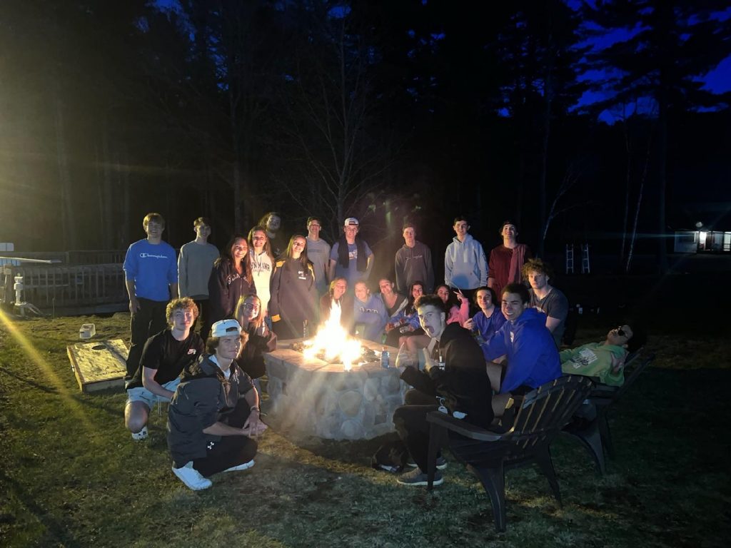 Group of people around an outdoor firepit