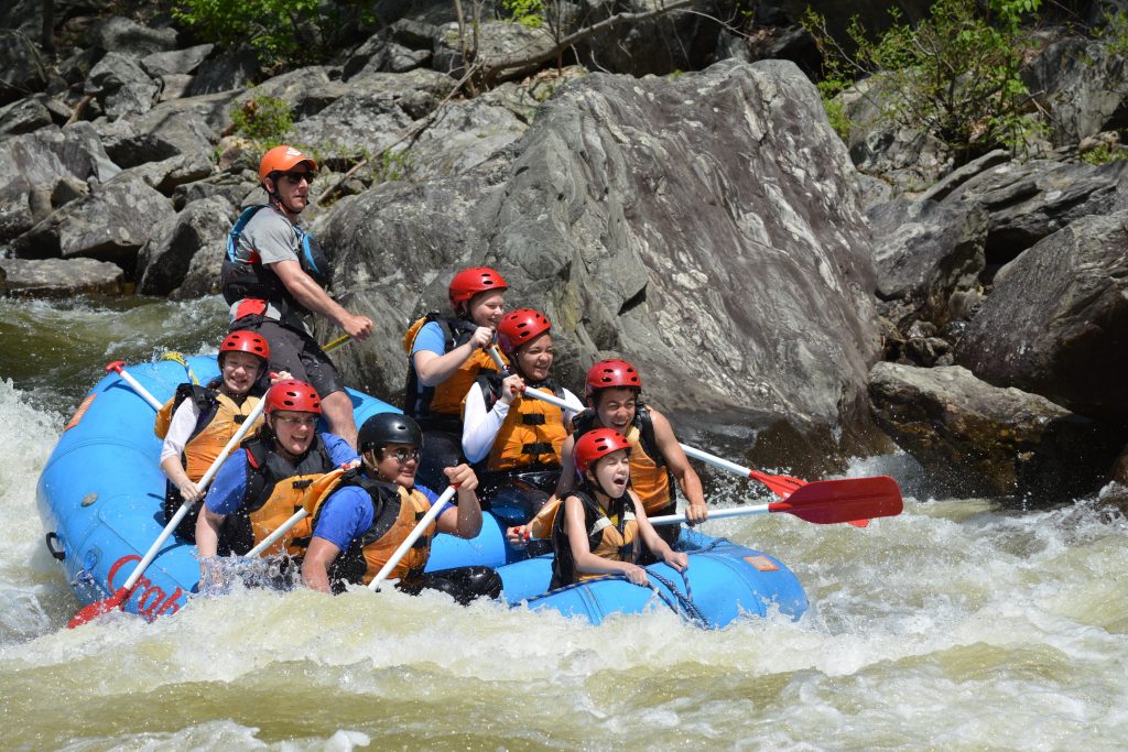 Raft with people and guide whitewater rafting